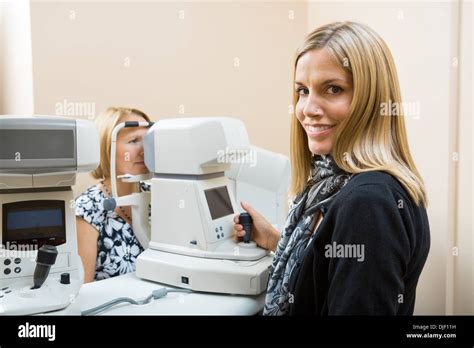 Optometrist Using Tonometer To Measure Patients Eye Pressure Stock