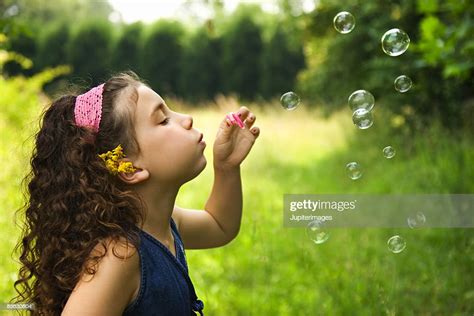 Girl Blowing Bubbles High Res Stock Photo Getty Images
