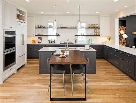 For more inspiring images original article and pictures take. Blond wood floors set a warm base in this U shape kitchen ...