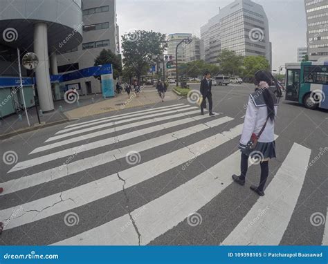 Typical Japanese School Girl Is Crossing The Street Editorial Image