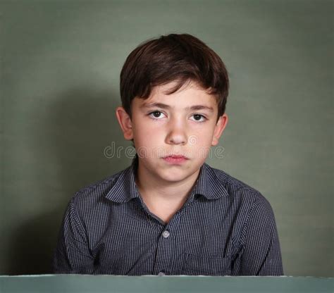 Close Up Portrait Of Young Sad Or Depressed Blonde Boy With Blue Stock