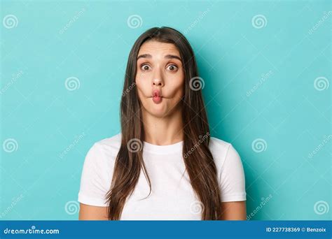 Close Up Of Silly Brunette Woman Sucking Lips And Showing Funny Faces