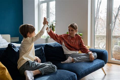 Older Sister Spending Time With Younger Brother At Home Stock Image
