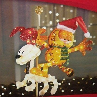 Set up a pretty display in a corner of your porch or at the edge of your lawn for a small but impactful decoration arrangement that doesn't overwhelm. Christmas outdoor lighted tinsel garfield odie carousel ...
