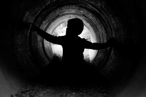 Child Silhouette A Young Child Exploring A Tunnel At A Pla Norbert