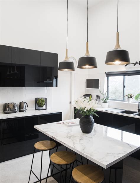 Technically, it only takes two colors to create a color scheme. This glam black and white kitchen balances family ...