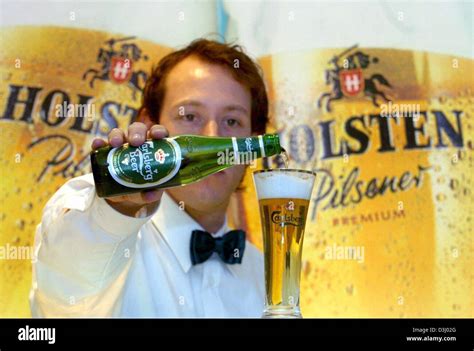 Dpa A Waiter Pours A Glass Of Carlsberg Beer As He Stands In Front