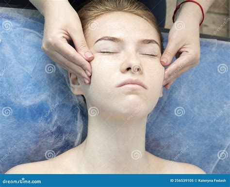 A Young Caucasian Beautiful Girl Lies On A Couch On A Facial Massage Procedure In A Beauty Salon