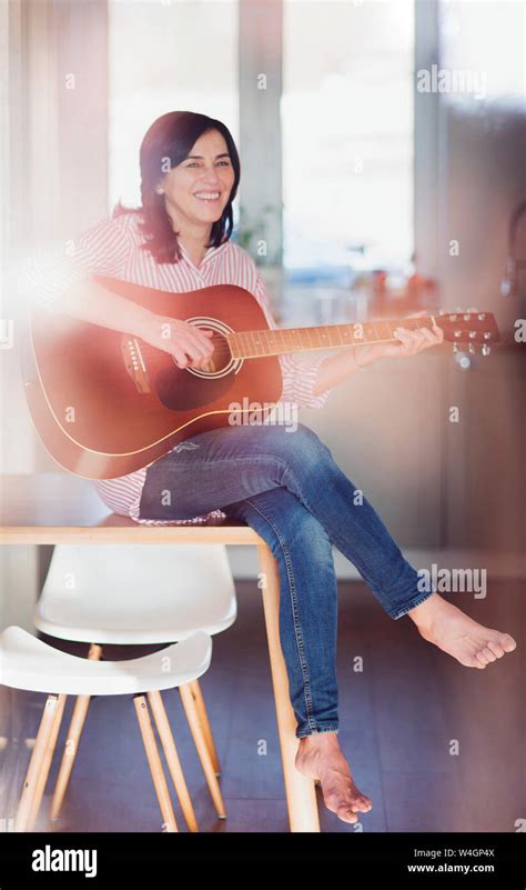Smiling Mature Woman Playing Guitar At Home Stock Photo Alamy