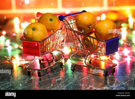 metal supermarket small cart on a background colored lights Stock Photo