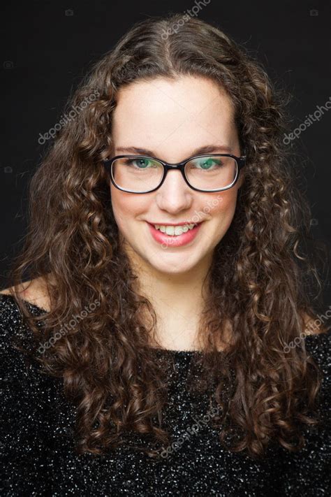 Smiling Pretty Girl With Long Brown Curly Hair Fashion Studio Portrait Isolated Against Black