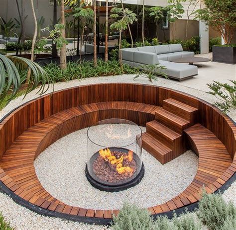 A Contemporary Sunken Fire Pit With A Built In Stained Bench And Steps