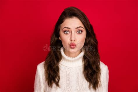 photo of nice optimistic brunette lady blow kiss wear white sweater isolated on vivid red color