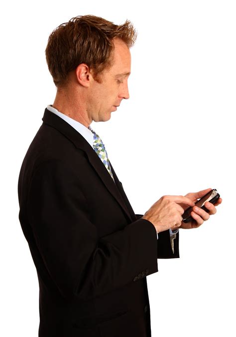 Texting Businessman | Free Stock Photo | A young businessman using a smart phone | # 13223