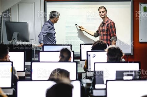Male Student Presenting A Lecture With Teacher At Computer Class Stock ...