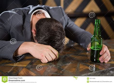 Drunk Man Lying On A Counter With Bottle Of Beer Stock Photo Image Of