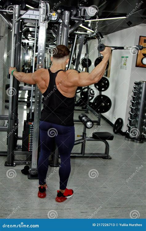 A Man With Big Muscles Is Engaged In Weightlifting In The Gym A Pumped