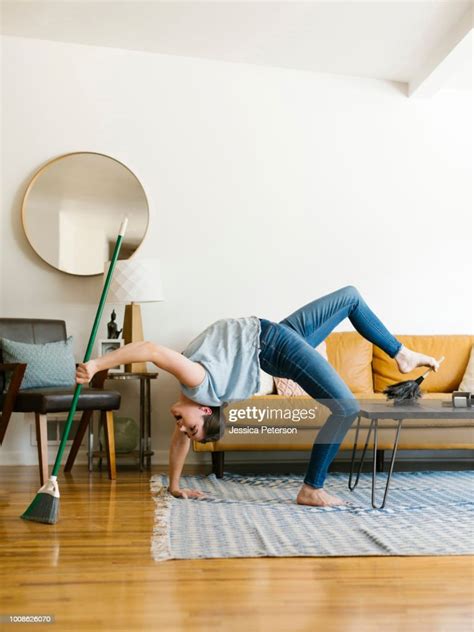 Woman Bending Over Backwards Sweeping And Dusting High Res Stock Photo