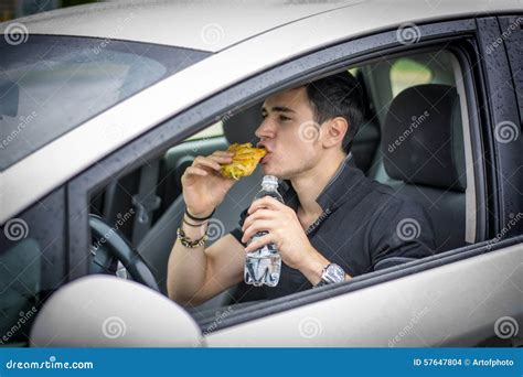 Young Man Driving His Car While Eating Food Stock Photo Image Of