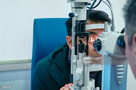 Eye Doctor Examining Patient Eyes After Lasik Surgery High Res Stock