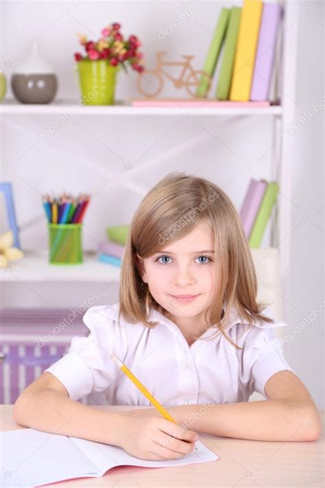 Little Girl Sitting At Desk In Room Stock Photo By ©belchonock 39042501