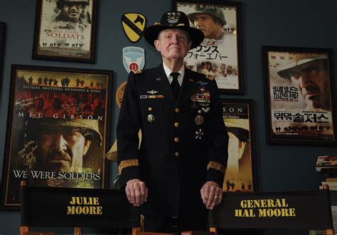 Lieutenant General Hal Moore Posing In Front Of Posters For The Movie