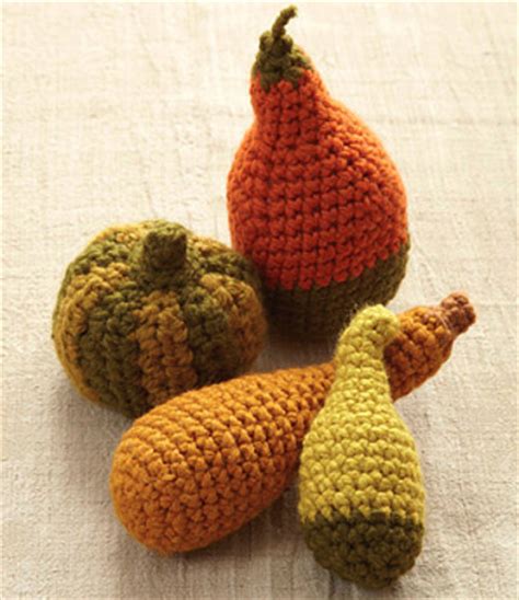 These easy thanksgiving decorations will keep your home feeling festive all november long. Festive Thanksgiving Crochet Gourds | AllFreeHolidayCrafts.com