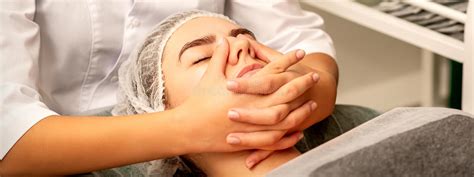 Beautiful Young Caucasian Woman With Closed Eyes Receiving A Facial Massage In A Beauty Salon