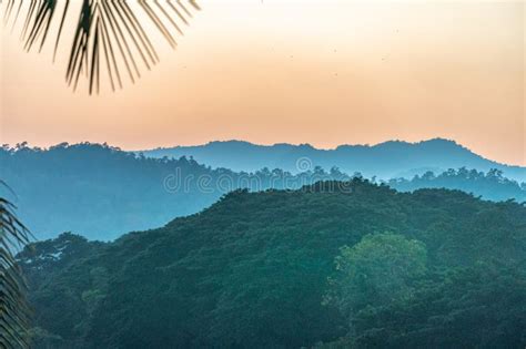 Sunset Over The Thai Burmese Mountains With River And Palm Tree Stock