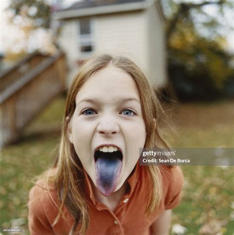Girl Sticking Out Blue Tongue High Res Stock Photo Getty Images