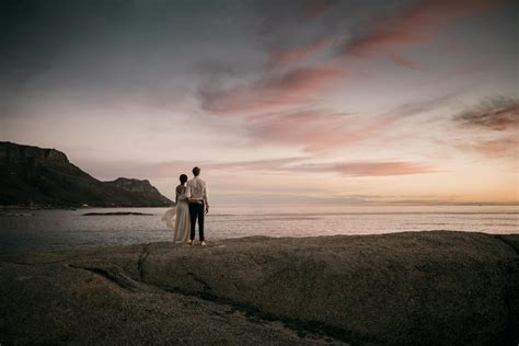 Couple Walking On Beach During Sunset · Free Stock Photo