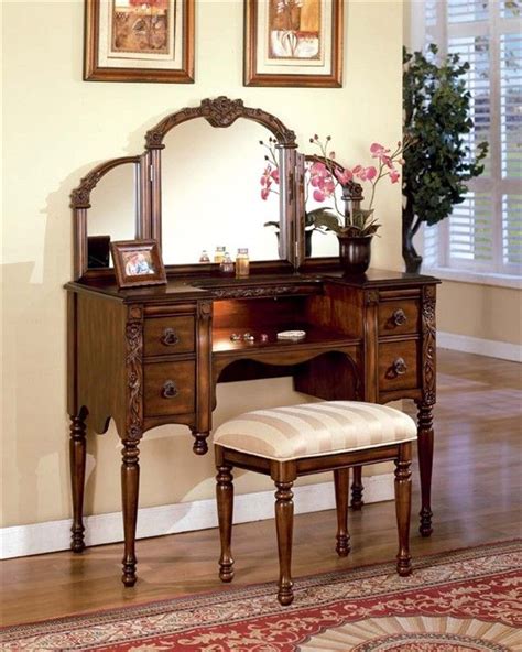 An Antique Vanity With Mirror And Stool In A Room