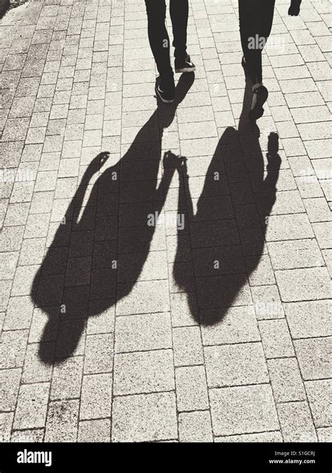 Shadow Of Couple Walking Holding Hands Stock Photo Alamy