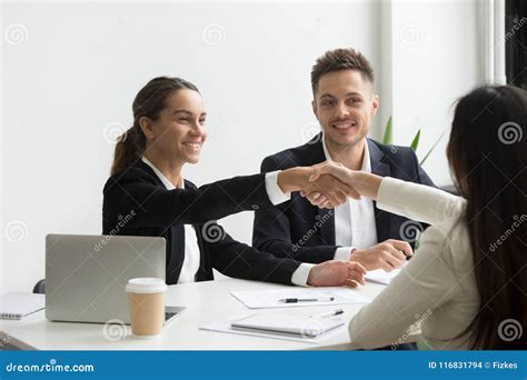 Hr Representatives Positively Greeting Female Job Candidate Stock Photo