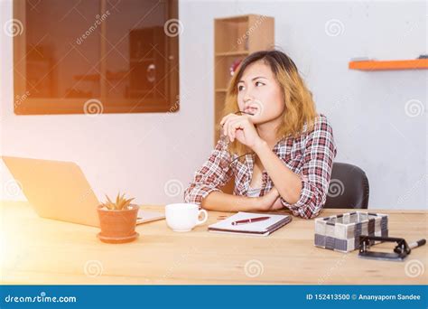 Business Woman Writing Something On Notepad In Office Stock Photo