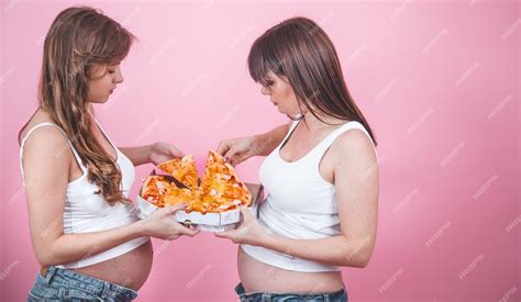 Free Photo Nutrition Concept Pregnant Women Eating Pizza On A Pink Wall