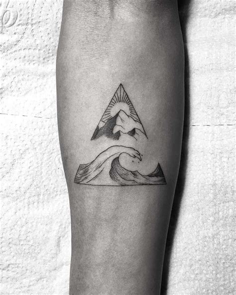 Wave And Mountain In A Triangle Tattooed On The Right Forearm
