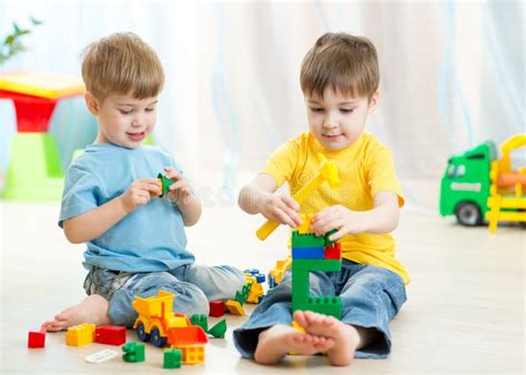 Kids Playing Toys In Playroom At Nursery Stock Photo Image Of