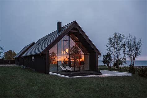 Summer House On An Estonian Beach Formed Of Two Black