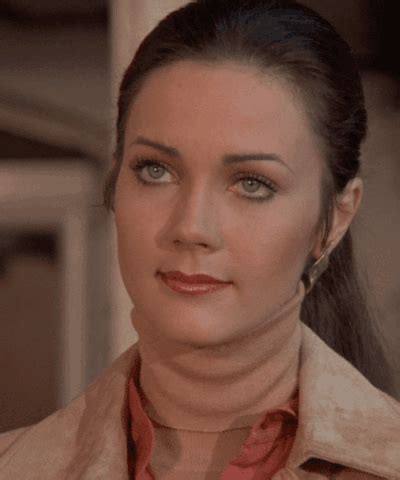A Woman With Blue Eyes Wearing A Tan Jacket