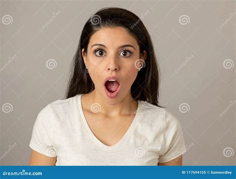 Young Attractive Woman With A Surprised And Shocked Face Eyes And Mouth Wide Open Stock Image
