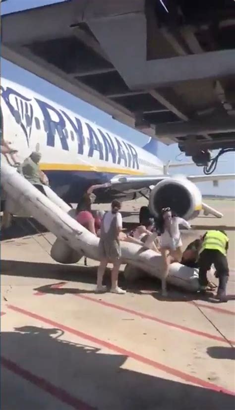 Dramatic Moment Ryanair Passengers Escape On Emergency Chute After Phone Catches Light Minutes