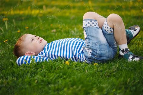 Little Boy Lying On The Grass High Quality Nature Stock Photos