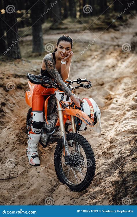 Female Racer Wearing Motocross Outfit With Semi Naked Torso Sitting On