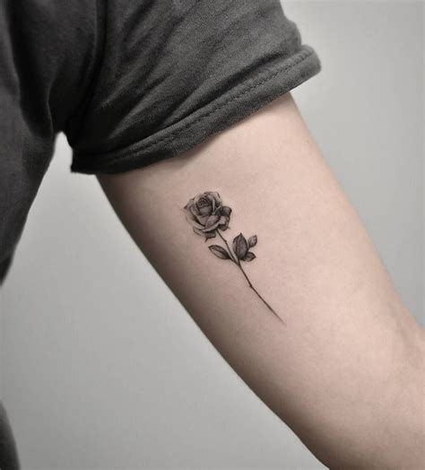 A Single Rose Tattoo On The Left Arm