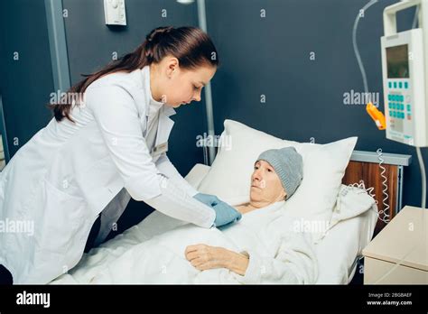 Oncologist Taking Care Of Elderly Woman Patient During A Chemotherapy