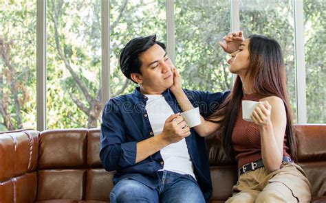 Asian Sweet Couple Boyfriend And Girlfriend Sitting On Sofa In Cozy