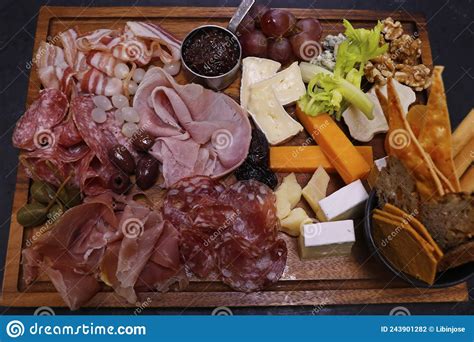 Assorted Cheese And Cold Meat Platter Or Board With Condiments Stock