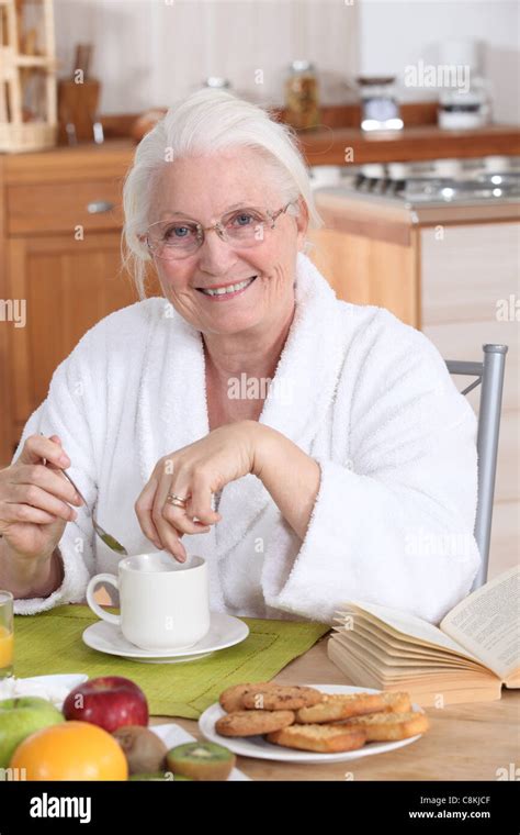 Granny In The Kitchen Having Breakfast Stock Photo Alamy