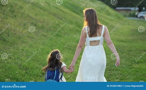 Happy Mother And Daughter Go Home Jumping On Grass At Sunset Stock Video Video Of Mother Bond